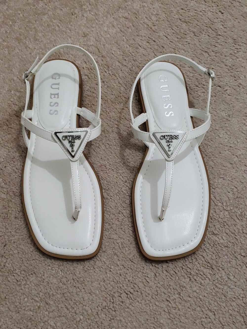 Guess Rainey T-Strap Flat Sandals In White With A Silver Guess Logo. Size: 9.5 M